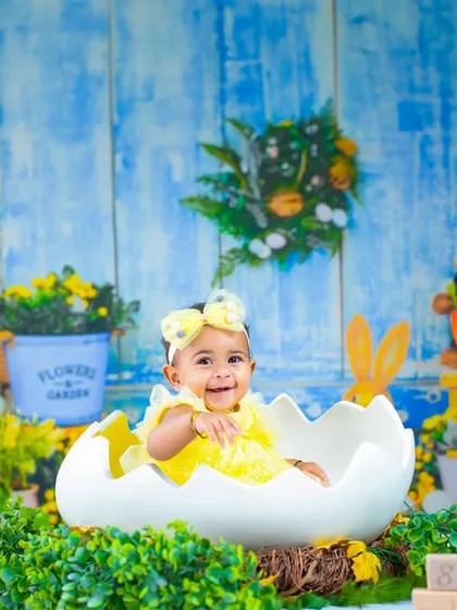 An adorable Easter-themed shoot, complete with real bunnies. This little one is hatching from a giant egg in a garden full of spring cheer.