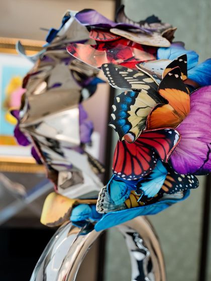 Another detail of "Flight to Infinity," showing the intricate layering of polycarbonate butterfly wings and crumpled metal.