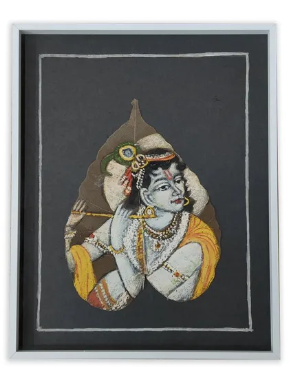 We specialize in framing even the most unusual items. This is a beautiful painting of Krishna on a real leaf, floated on a dark background and housed in a simple white frame to preserve its natural form.