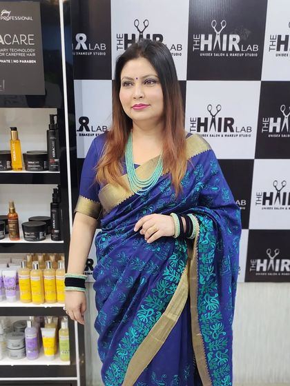 A happy client posing in the salon after her hair color service. Her new color and style look elegant and perfectly suited for her.