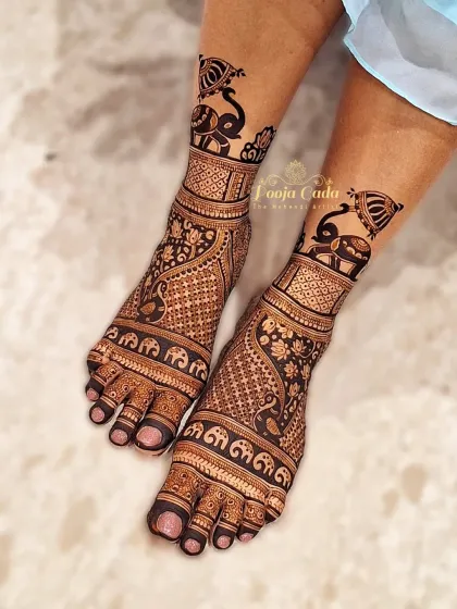 A bold and beautiful feet design featuring a parade of elephants and intricate jaal work, perfect for a royal bridal look.