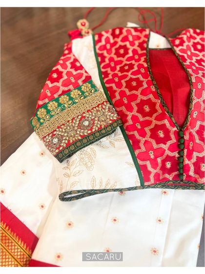 A close-up of the patchwork blouse, detailing the button-down front, the different fabrics used, and the embellished sleeve cuff.