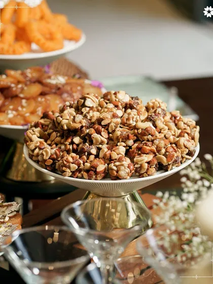 A beautiful display of Indian sweets and savouries, including a delicious nut chikki. Our presentation turns traditional favourites into an art form, perfect for festive gatherings at home.