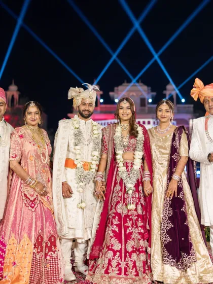 A perfect family portrait from the wedding day. The bride stands radiant in the center, her makeup and hair looking impeccable alongside her beautifully dressed family.