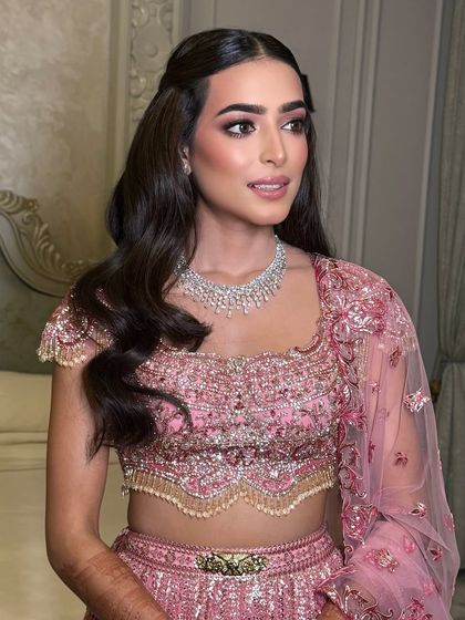 A simple and elegant half-up style with soft waves, perfect for a bride who wants a timeless look.