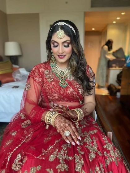 A moment of reflection. The bride's soft glam makeup and elegant jewelry are perfectly captured as she prepares for her big day.