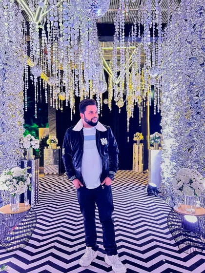 Making my days masterpieces. A stylish photo of me standing in a stunning, brilliantly lit, and decorated event space.