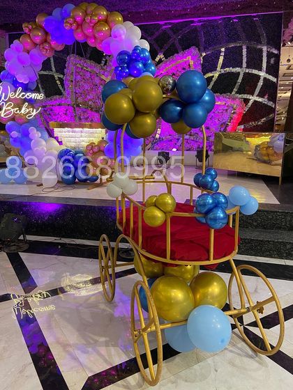 As part of the welcome celebration, I decorated this beautiful golden pram with balloons. It serves as a wonderful prop for photos and the baby's grand entrance.