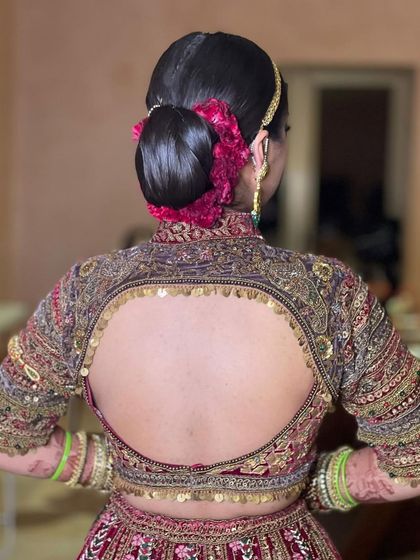 The clean lines of this sleek bridal bun create a very royal and polished look, perfect for a grand wedding ceremony.