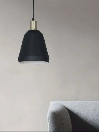 A ravishing hanging light with a black and white cone-shaped shade and an antique brass fitting. Its minimalist design is perfect for modern interiors, whether hung alone or in a series.