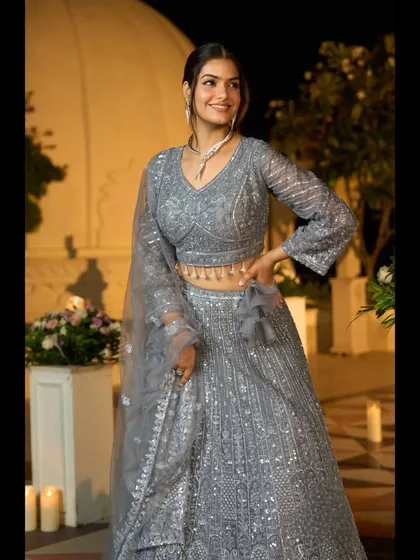 Another view of the grey sequin lehenga, highlighting the flattering V-neck blouse with its bell sleeves.