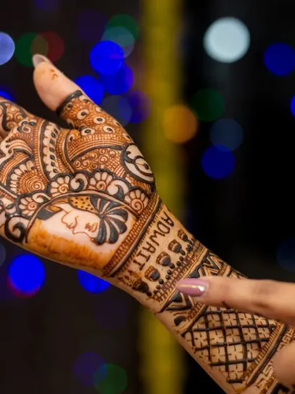 Another angle of the bride's beautiful henna art, with her groom's name, Adwait, elegantly written into the design.