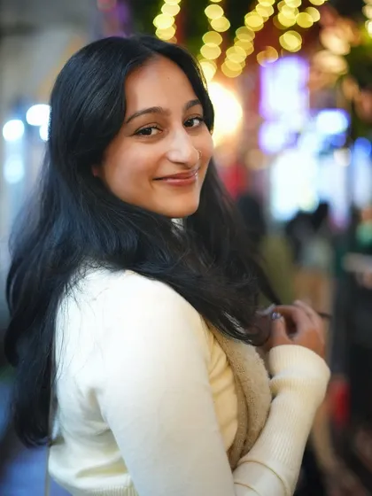 A candid, over the shoulder smile. This engaging pose and the magical bokeh make for a perfect, spontaneous-looking night portrait.