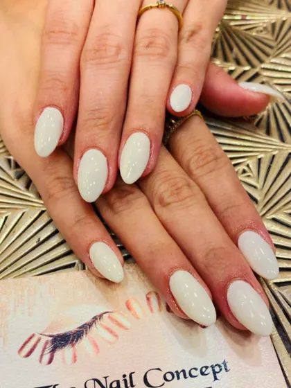 A clean and simple set of almond-shaped nails in a solid, milky white color. This versatile look is modern, chic, and goes with everything.