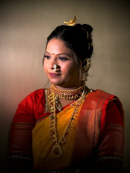 A beautifully lit portrait of the bride. The soft lighting enhances her features and the subtle shimmer of her makeup.