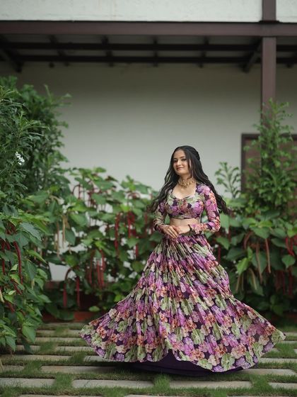 A dreamy, ethereal lehenga for the modern woman. This piece features a flowing, pleated skirt with a soft floral print, paired with a matching full-sleeve blouse for a look of effortless elegance.