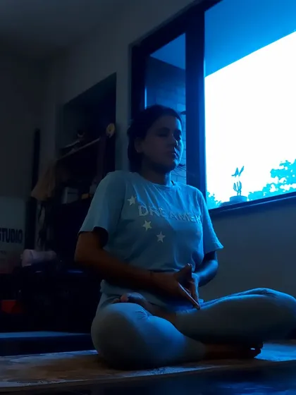 A student in deep meditation, practicing Yoni Mudra to calm the mind and balance their inner energies.