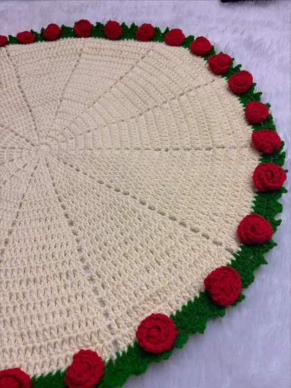 Here is the rose blanket laid flat, showing the full circular design and the beautiful border of red roses and green leaves.