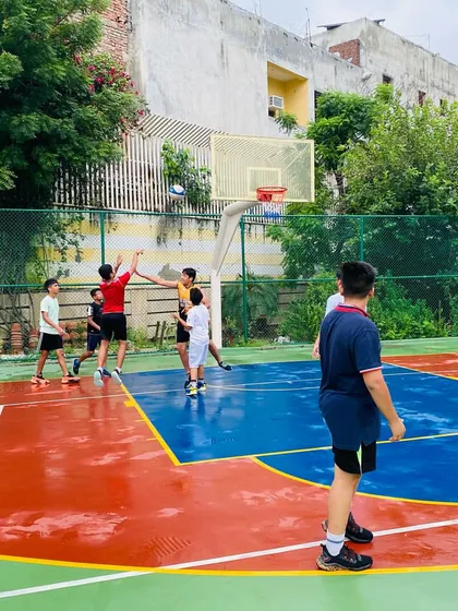 A player takes a jump shot on a wet court.