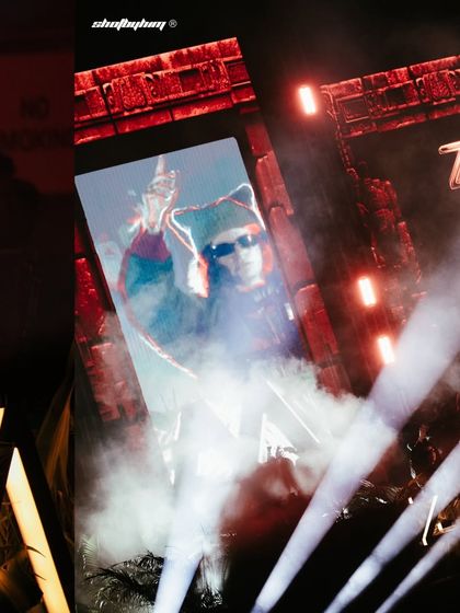 A collage from Carlita's set at Zamna, showing her on the big screen and the powerful beams of light shooting out over the crowd.