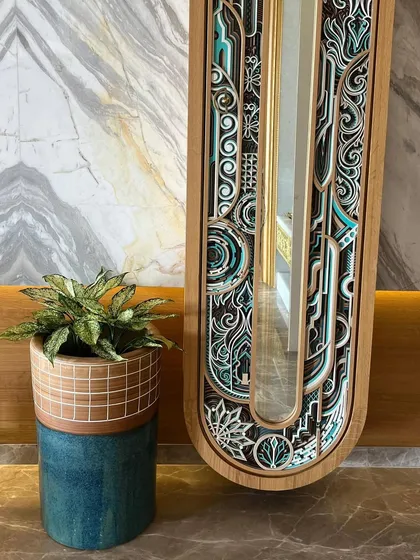 This two-toned ceramic planter, with its unique texture and colour combination, adds an artistic touch next to an ornate mirror.