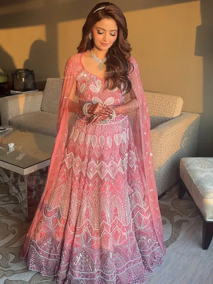 Another shot of the beautiful pink reception lehenga. The look is elegant, modern, and utterly romantic.