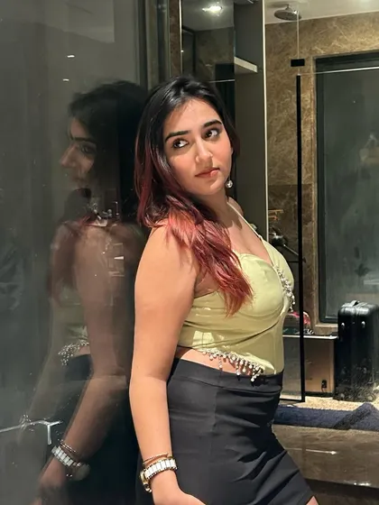 A mirror selfie showing off a lime green corset with rhinestone details from Lulu & Sky. This type of content is great for highlighting trendy, statement pieces.