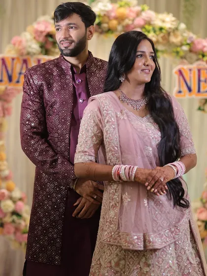 The couple posing together at their engagement. The bride's soft glam makeup looks beautiful next to the groom's coordinated attire, creating a perfect picture.
