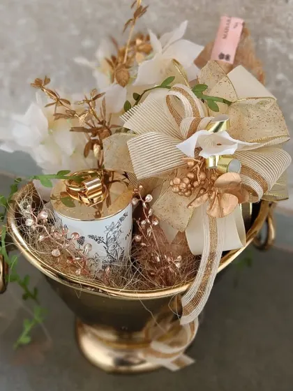 A celebratory bottle nestled in our bestselling Champagne Bucket, adorned with a custom floral arrangement. This is how we turn a classic gift into an unforgettable, luxurious experience.