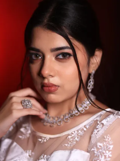 A striking close-up of a Christian bridal look. The focus is on the defined, winged eyeliner and soft nude lip, creating a modern yet timeless appeal.