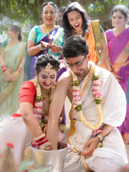 A fun-filled ritual that brings out laughter from the couple and their families, showcasing the joyful side of wedding traditions.