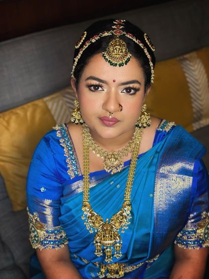 A direct portrait of the bride, her eyes open, showing the full impact of the classic, subtle makeup.