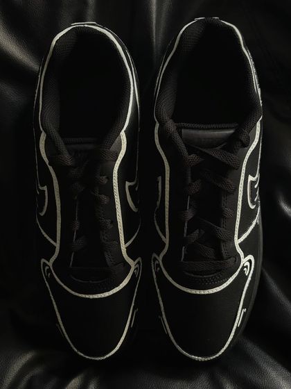 A front view of the black and white cartoon custom sneakers.