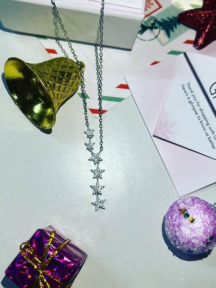 A beautifully styled flat-lay of the Giva necklace with Christmas ornaments, creating a perfect gifting vibe for the holiday season.