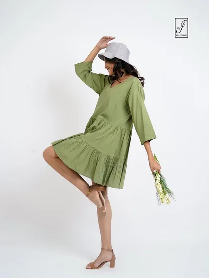 A duplicate shot showing a playful, one-legged stance.