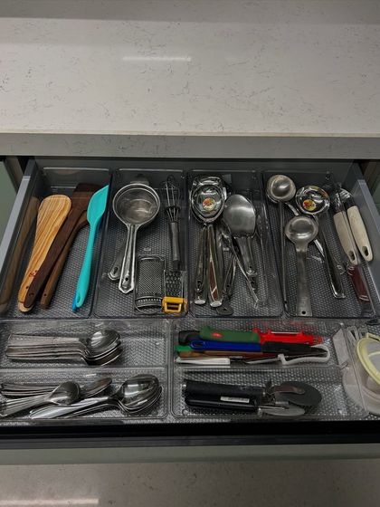 A utensil drawer with clear tray inserts. This creates a clean, modern look and makes it easy to wipe down the drawer.