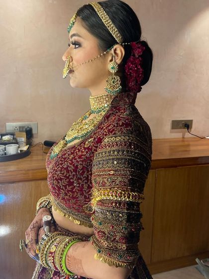 A side profile showing the neatness of the sleek bun and how it provides a perfect base for the matha patti and other hair jewelry.