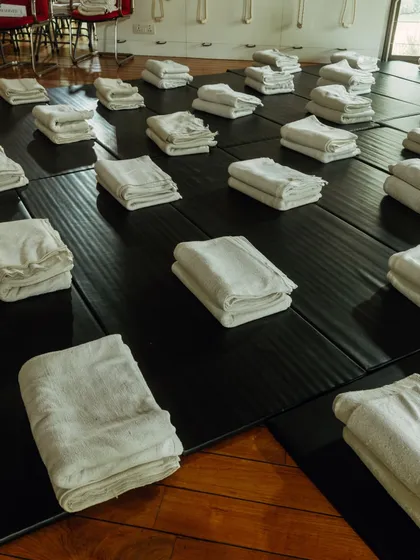 These images offer a tour of Yogakshema. From the serene pond with lotuses to the carefully arranged practice hall and the beautiful pathway decorated for an event, every corner of my center is designed to inspire peace and mindfulness.