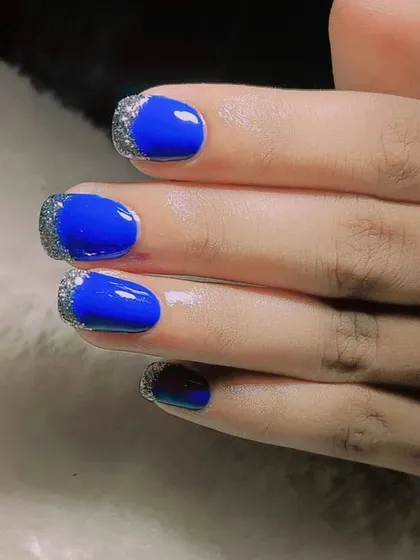Beating the summer heat with these gorgeous and minimal glam nails. The bold blue is paired with a silver glitter French tip.