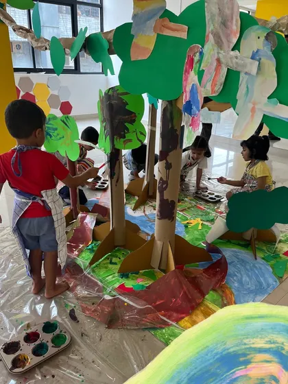 Here, our artists are building and painting their own 3D forest installation. This shows how we encourage children to think beyond the flat page, working together to create an immersive environment. It’s a hands-on lesson in collaboration, construction, and creativity.