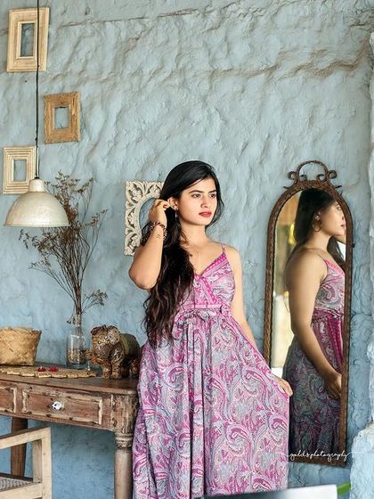 A collection of relaxed, bohemian-style portraits taken at a rustic cafe. The model is featured in a flowing paisley dress, interacting with props like a guitar, creating a natural and artistic vibe.