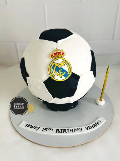 A sculpted football cake with the Real Madrid logo, perfect for a true fan's 15th birthday.