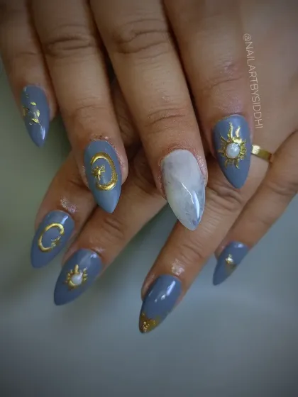 A mystical, celestial-themed set in a dusty blue, featuring golden sun, moon, and star charms.