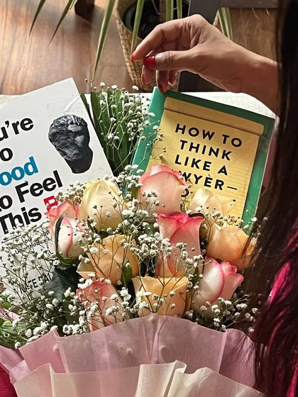 A close-up of the book bouquet, featuring "How to Think Like a Lawyer." It is a reminder that learning is a continuous journey, and there is always a new perspective to discover.