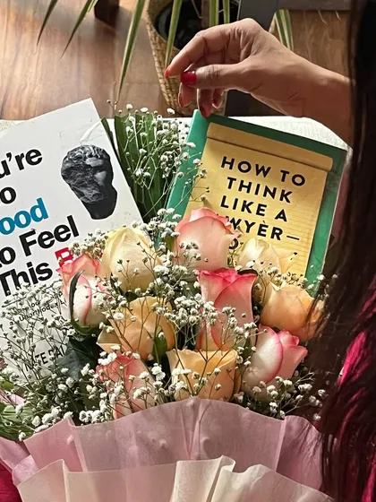 A close-up of the book bouquet, featuring "How to Think Like a Lawyer." It is a reminder that learning is a continuous journey, and there is always a new perspective to discover.