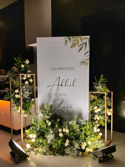 Another view of the chic welcome sign. The clean lines of the sign and the golden frames of the floral stands create a look that is contemporary and sophisticated.
