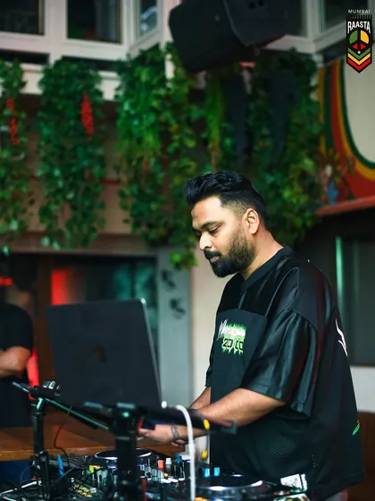 Focused on the mix during a set at Raasta Bombay. It's about selecting the right track at the right moment.