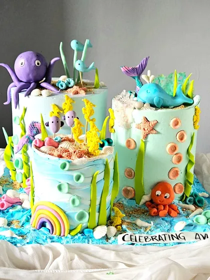 I love creating immersive experiences, like this deconstructed "Under the Sea" cake. Each tier is a separate part of a larger ocean scene, filled with handcrafted sea creatures, making it a fun and interactive dessert display for a big celebration.
