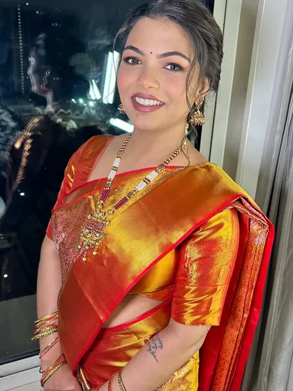 A happy bride smiling for the camera, her engagement makeup is soft and radiant.