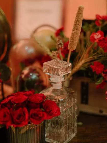 A crystal decanter and red roses complete the vintage, speakeasy vibe.